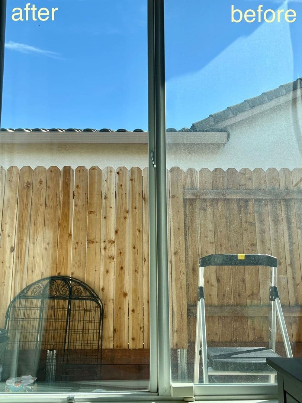 Clean window comparison showing "before" and "after" views of a backyard with wooden fence.